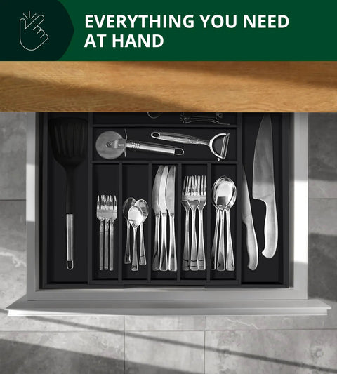 Overhead view of bamboo kitchen drawer with black utensil tray and cutlery in 9 grooved slots