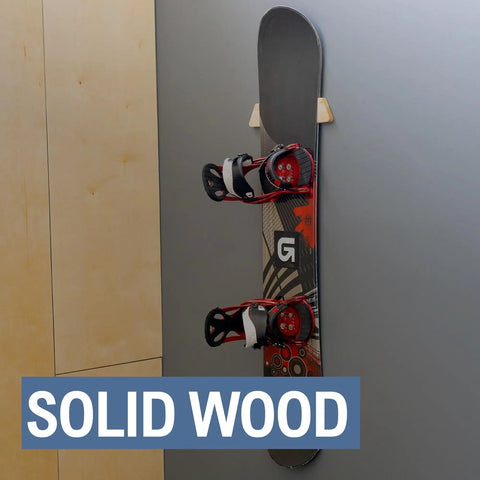 Sturdy Solid Wood Snowboard Rack Wall Mount For Home Or Garage Featuring Adjustable Width And Tight Grip Supports Holding Up To Thirty Pounds Hella Smooth Gear Storage, displaying a snowboard secured against a wall.