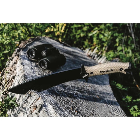 Camp 10 Machete 10 Inch Recurve Fixed Blade resting on a log, featuring 65Mn carbon tool steel and tan handle, outdoors.