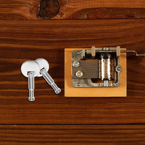 Music Box Winding Key Replacement Round Handle 1.57 Inch For Standard Movements on wooden table with metal parts