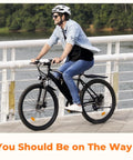 Man riding Beast Mode 1500W Peak Electric Bike For Adults with dual disc brakes and adjustable seat on bridge