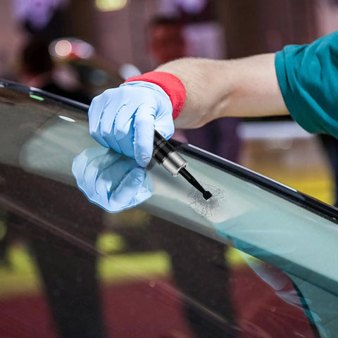 Car Windshield Crack Repair Kit With Nano Glass Repair Fluid being applied to windshield by worker in gloves