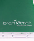 Heavy Duty Silicone Non Stick Dehydrator Mats For 6 Tray Ovens And Countertops Tough No Fuss Kitchen Baking Sheets For Fruit Roll Ups Crackers And Jerky Legit Teflon Free Flat Dry Trays with bright kitchen logo on green surface.
