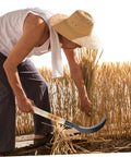 Person using Long Handled Mowing Knife Garden Hoe With Wooden Handle For Weeding And Harvesting Multipurpose Gardening Tool