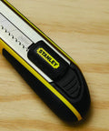 Close-up of the FatMax Snap Off Knife, durable utility knife with ergonomic grip and easy blade change on wooden surface.