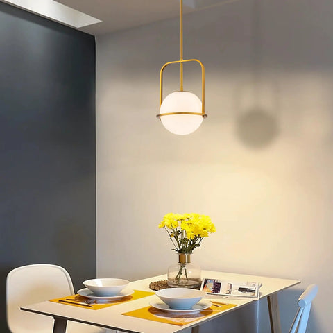 Slick Brass Pendant Light For Kitchen Island With Adjustable Height And Soft Frosted Glass Globe Ceiling Lamp For Dining Room Entryway Bedroom Modern Hanging Fixture Top Shelf Home Decor above dining table with yellow flowers.