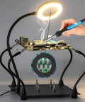 Soldering Magnifying Glass With Four Arm Magnetic Holder And 3X LED Light in use for circuit board repair, showing flexible arms and base.