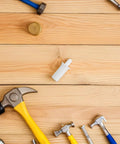 Killer Quality 50 Pack Shutter Repair Pins Spring Loaded Plantation Shutter Fasteners on wooden surface with tools.