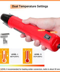 Person holding mini heat gun with dual temperature settings, part of All-In-One Compact Heat Shrink Gun Kit With 820 Solder Seal Connectors And Heat Shrink Tubing, Waterproof Wire Repair Bundle For Marine And Automotive Wiring, Mini Heat Gun Delivers 482 To 752 Fahrenheit, Includes AWG26-10