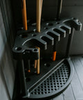 Compact Corner Tool Rack For Maximum Garden Tool Storage And Organization Holds Up To 25 Long Handled Tools Like Rakes Shovels Brooms And Accessories Easy Assembly In Under 5 Minutes All Weather Durable Zero Maintenance shown in a corner with tools
