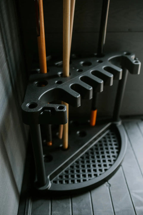 Compact Corner Tool Rack For Maximum Garden Tool Storage And Organization Holds Up To 25 Long Handled Tools Like Rakes Shovels Brooms And Accessories Easy Assembly In Under 5 Minutes All Weather Durable Zero Maintenance shown in a corner with tools