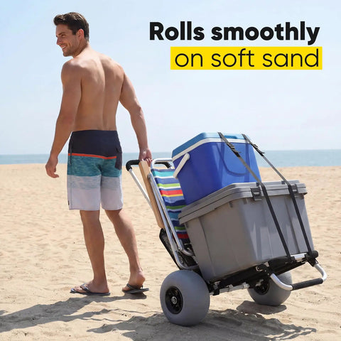 Beach Wagon With 12 Inch Massive Wheels For Sand And All Terrain Hauling, carrying coolers on a beach by a person