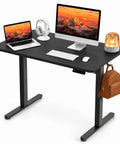 AdGiGi 40 Inch Electric Standing Desk Adjustable Height Sit Stand Workstation Compact Computer Table For Home Office Small Space Black with dual monitors, keyboard, and accessories.