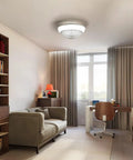 15 Inch Enclosed Bladeless Ceiling Fan with RGB Dimmable LED Light in modern living room setting with cozy sofa and desk