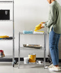 Person using Beefy Heavy Duty Steel Wire Shelving Rack With Chrome Finish 3 Shelf Adjustable Storage System No Tool Assembly