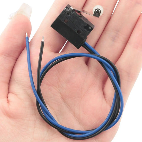 Black Waterproof Micro Switch With Roller Lever IP67 Sealed Limit Switch For Rugged Environments in hand, compact size.