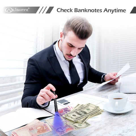 Man using 365Nm UV Flashlight Beast Power Black Light for checking banknotes on a desk with coffee and documents.