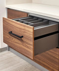 Matte Black Cabinet Handles Set Of 10, 5 Inch Center To Center, shown on a wooden kitchen drawer.