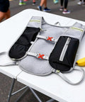 Hydration Backpack For Hiking And Trekking, Outdoor Waterproof Gear, unisex, with adjustable straps on a table next to bananas.