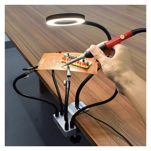 Third Hand Desk Clip Soldering PCB Holder Tool With 3X LED Magnifier in use on wooden table, showing adjustable gooseneck arms.
