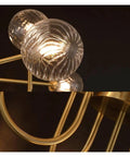 Close-up view of Nordic Minimalist Magic Bean LED Pendant Lamp French Glass Ball U-Shaped Chandelier with gold accents.