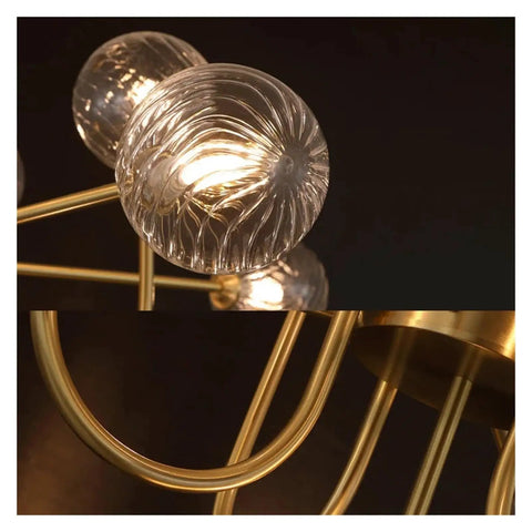 Close-up view of Nordic Minimalist Magic Bean LED Pendant Lamp French Glass Ball U-Shaped Chandelier with gold accents.