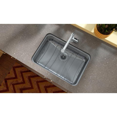 Top view of a kitchen sink with a stainless steel bottom grid, 23 by 15 inch, protective feet visible.