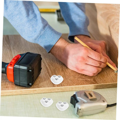 Person using a pencil to mark wood surface with Eight Piece Stainless Steel Self Adhesive Caster Wheels With Smooth Ball Bearings For Effortless Furniture Relocation And Heavy Duty Storage Box Glide Conversion Today.
