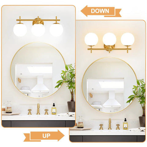 Next Level Three Light Bathroom Vanity Lights In Brushed Gold Finish With Milky White Glass Globe Shades Modern Wall Sconce Over Mirror, shown in up and down orientations above round mirror.