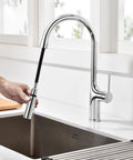 SUMERAIN Kitchen Faucet with Pull Down Sprayer Dual Mode Brushed Gold with hand holding sprayer in kitchen setting.
