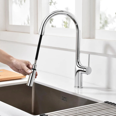 SUMERAIN Kitchen Faucet with Pull Down Sprayer Dual Mode Brushed Gold with hand holding sprayer in kitchen setting.