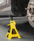 Front view of a yellow steel 3-ton car jack stand with locking pin and wide base under a vehicle.