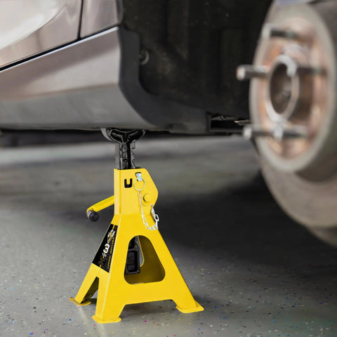 Front view of a yellow steel 3-ton car jack stand with locking pin and wide base under a vehicle.