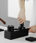 Person using Walnut 4 In 1 Espresso Knock Box And Tamping Station With Portafilter Holder Tamper Holder And Distributor Holder