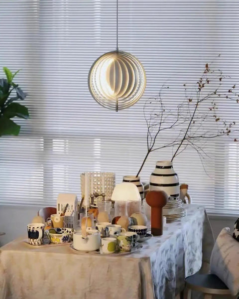Dope 360 Degree Adjustable Moon Pendant Light With Rotating Sphere Shade above dining table in modern living space