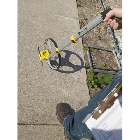 Rolatape RT312 12.5 Inch Aluminum Measuring Wheel Built To Last With Lightweight Durable Design For Landscaping And Construction, Ergonomic Pistol Grip, Yellow Great For Yards And Job Sites on sidewalk