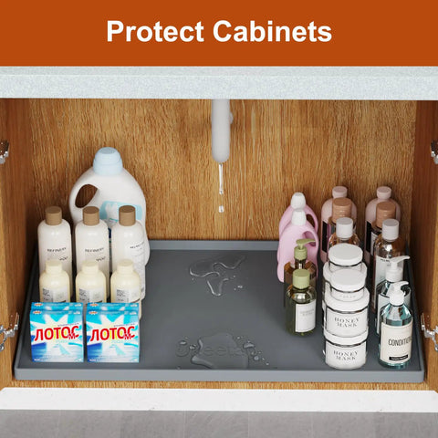 Leakproof Silicone Mat With Raised Edge Extra Thick Under Sink Mat For Kitchen And Bathroom Waterproof Cabinet Liner placed in cabinet with bottles.