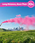 Epic Gender Reveal Fire Extinguisher 2 Pack Color Powder Blaster With Biodegradable Smoke For Baby Shower Party Supplies And Big Blowouts That Shoots Over Ten Feet For Hella Awesome Straight Up Celebrations, man using pink smoke blaster in a field.