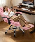 Woman relaxing in a Comfy Reclining Office Chair With Footrest For Women, Pink, at a gaming desk, showcasing the footrest feature.