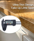 Ultra Thin Magnetic Cabinet Catch Set, 4 Pack Stick-On Drawer Magnets measuring 0.14 inches on a kitchen cabinet.