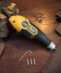 Electric engraver tool with attached engraving bit and wooden blocks around