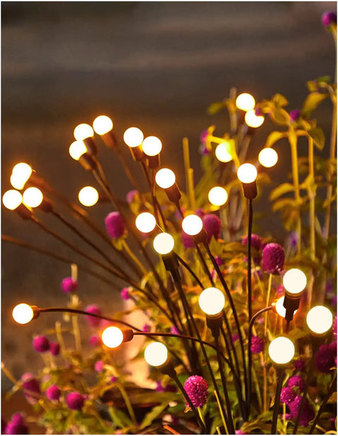 Solar Firefly Pathway Lights 6 Pack Warm White LED Garden Decor Waterproof Outdoor Solar Powered Lights With Wind Sway And 8 Flicker Modes For Yard And Patio Pathway Vibe glowing among flowers at night