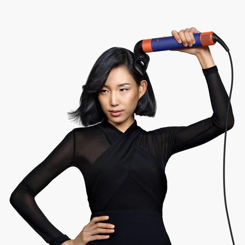 Woman using Blade Concentrator For Airwrap Styling Tool With Focused Airflow To Style One Section At A Time Without Disturbing The Rest Pro Grade And Compatible With All Airwrap Generations.
