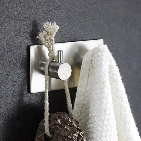 Heavy Duty Stainless Steel Wall Mounted Hooks Featuring Super Strong Self Adhesive Tape For Bathroom Towels Coats And Home Organization No Drill Hassle Rust Proof Daily Setup with white towel.