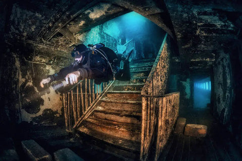 Scuba diver exploring a wreck wearing Zen Deluxe Single Tank Scuba BCD With Narrow Zen Wing For Superior Buoyancy Control.