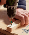 Person using a drill to install screws from the Built Tough 304 Stainless Steel Wood Screws And Self Tapping Assortment Kit 450 Piece Set.