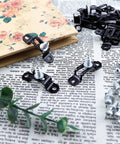 Premium Heavy Duty 60 Piece Concealed Furniture Slide Connectors And Snap On Buckle Fasteners For Rock Solid Cabinet Assembly Tool Free Half Pass Hardware Kit Bundle, black connectors on newspaper background.