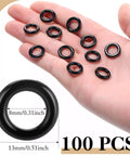 One Hundred Black Plastic Roman Blind Curtain Rings O Rings For Window Treatments Smart Cord Guides, shown in hand.