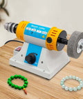 Pro Grade Bench Top Polisher And Grinder For Sanding Grinding And Polishing With 320W Motor And Variable Speed 800 To 10000 RPM 110V Yellow Industrial Tool Includes A Full Accessory Kit For Workshops Makers And DIYers placed on a wooden table.