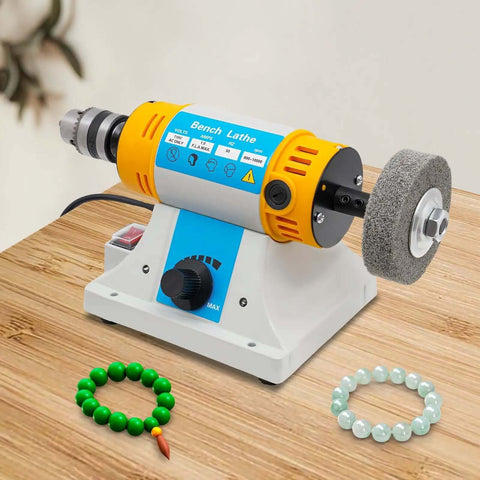 Pro Grade Bench Top Polisher And Grinder For Sanding Grinding And Polishing With 320W Motor And Variable Speed 800 To 10000 RPM 110V Yellow Industrial Tool Includes A Full Accessory Kit For Workshops Makers And DIYers placed on a wooden table.